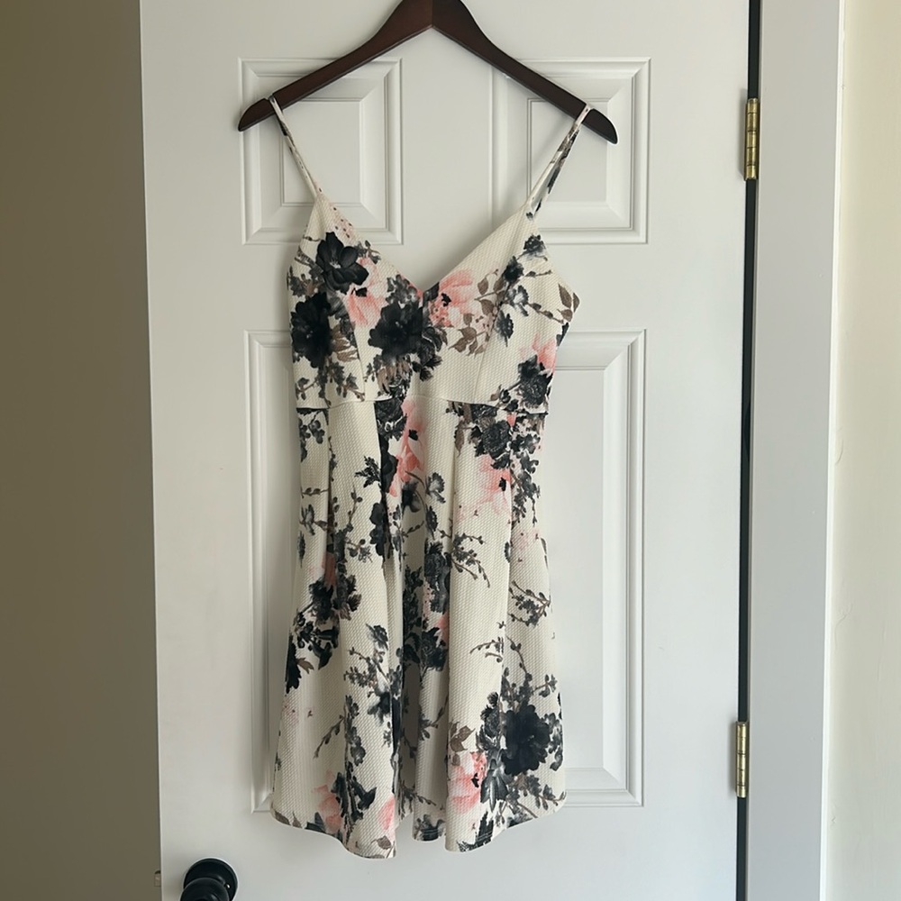 Dark floral print on white dress with pink flowers.